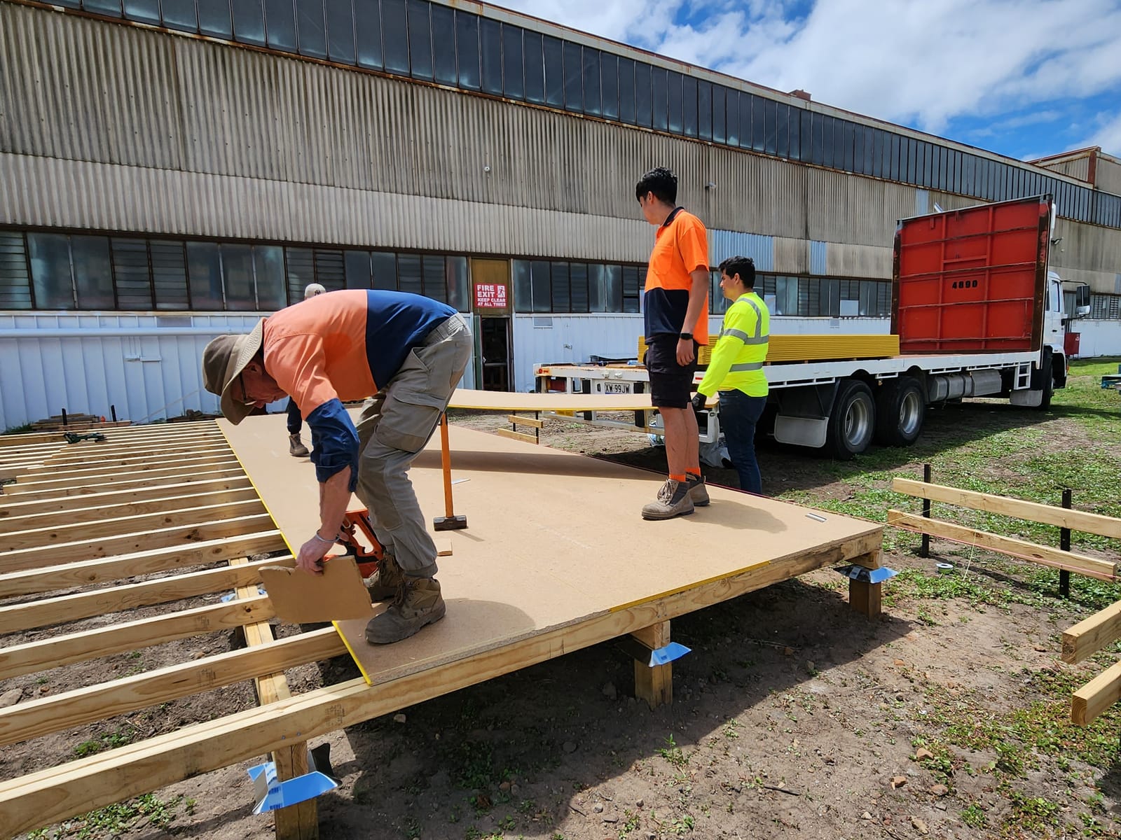 Calima labourers building a timber platform on an outdoor site