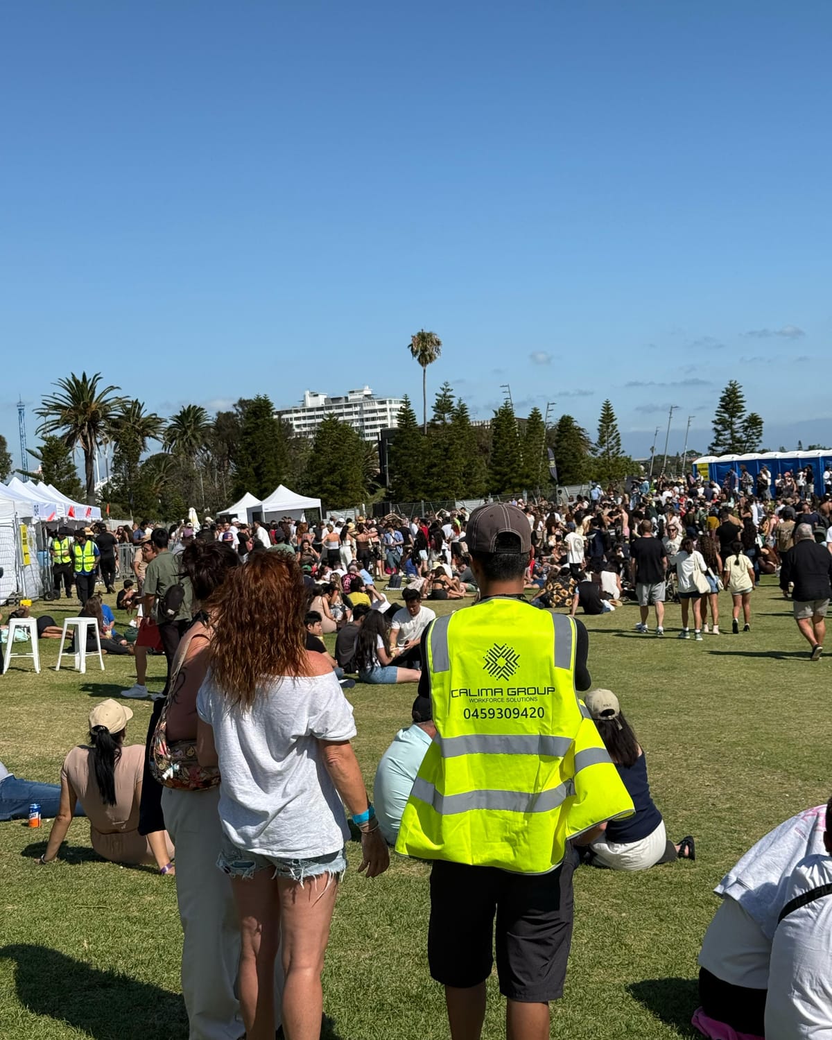 Calima crew member in branded hi-vis overlooking a festival crowd in Melbourne