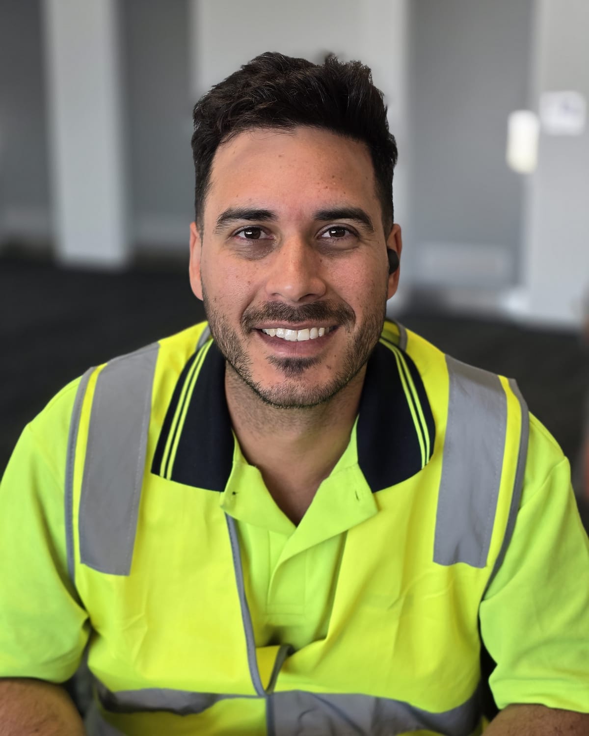 Smiling Calima worker in a high-visibility vest